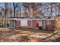 Brick ranch house with carport and red front door at 2970 Eleanor Nw Ter, Atlanta, GA 30318