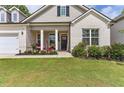 Front porch of a two-story house with brick and gray siding at 445 Carmichael Cir, Canton, GA 30115