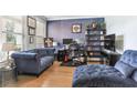 Home office with hardwood floors, two sofas, and built-in shelving at 445 Carmichael Cir, Canton, GA 30115