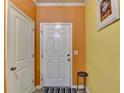 Bright entryway with orange and yellow walls, white door, and tile flooring at 1189 Indian Creek Pl, Stone Mountain, GA 30083