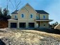 Two-story house with light beige siding, a covered porch, and a three-car garage at 162 Silvercrest Dr, Acworth, GA 30101