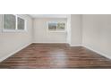 Simple bedroom with dark wood floors and window at 1983 Wee Kirk Se Rd, Atlanta, GA 30316