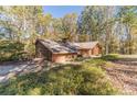 Brick and wood house with attached garage and wooded lot at 2612 Country Club Se Dr, Conyers, GA 30013