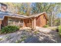 Front entrance of a brick and wood house with a walkway at 2612 Country Club Se Dr, Conyers, GA 30013