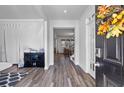 Bright foyer with wood-look flooring leading to the staircase and main living area at 3330 Deaton Trl, Buford, GA 30519