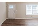 Living room featuring hardwood floors and a white door at 4412 Rustic Wood Dr, Stone Mountain, GA 30083