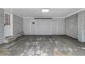 Spacious two car garage has plenty of room for storage with newly painted doors and brick accent wall at 2418 Brookdale Ne Dr, Atlanta, GA 30345