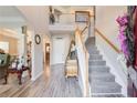 Bright foyer featuring hardwood floors, staircase with wood railing, and soaring ceilings for a grand entrance at 3258 Kessock Ridge Trl, Snellville, GA 30039