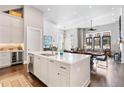 Bright, open kitchen featuring a large island, stainless steel appliances, and hardwood floors at 6750 Avis Walk, Alpharetta, GA 30005