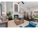 Spacious living room with a fireplace, stylish furniture, and hardwood floors; kitchen visible in background at 6750 Avis Walk, Alpharetta, GA 30005