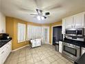 Eat-in kitchen with stainless steel appliances and white cabinets at 75 Maygold St, Mcdonough, GA 30253