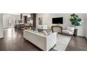 Open living room with hardwood floors, stylish furniture, and a view into the kitchen at 241 Maynard Se Ter # 14, Atlanta, GA 30316