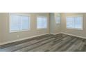 Well-lit bedroom with wood-look floors and multiple windows at 3293 Hobart Nw Dr, Atlanta, GA 30318