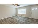 Bright living room featuring wood-look floors and a large window at 3293 Hobart Nw Dr, Atlanta, GA 30318