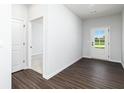 Welcoming foyer offers dark wood-look flooring, white trim, and a glass-paneled entry door at 313 Chattahoochee Cir, Locust Grove, GA 30248