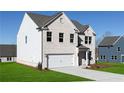 A delightful two-story residence with white brick, attached garage, and meticulously maintained lawn at 313 Chattahoochee Cir, Locust Grove, GA 30248