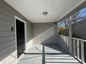 Covered front porch with black door and gray railings at 854 Fayetteville Se Rd, Atlanta, GA 30316