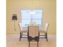 Dining area with glass table and four chairs at 2024 Appaloosa Way, Conyers, GA 30012