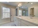 Double vanity bathroom with white cabinets and a large mirror at 4521 Twinberry Dr, Powder Springs, GA 30127