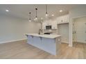 Modern kitchen with white cabinets and a large quartz island at 4521 Twinberry Dr, Powder Springs, GA 30127