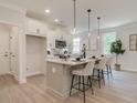 Modern kitchen features white cabinets, quartz countertops, and an island with seating at 4521 Twinberry Dr, Powder Springs, GA 30127