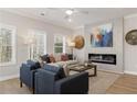 This living room features bright natural light, an electric fireplace, and modern furnishings at 4521 Twinberry Dr, Powder Springs, GA 30127