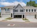 Two-story townhouses with gray siding, attached garages, and landscaping at 4529 Twinberry Dr, Powder Springs, GA 30127