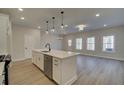 Modern kitchen, white cabinets, quartz countertops, island with seating at 4529 Twinberry Dr, Powder Springs, GA 30127