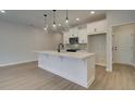 White kitchen with island and stainless steel appliances at 4529 Twinberry Dr, Powder Springs, GA 30127