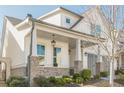 Inviting porch features brick supports, hanging lights, and space for relaxation at 104 Ivey Way, Woodstock, GA 30188