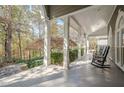 Spacious front porch with rocking chairs and view of wooded area at 2727 Jamerson Rd, Marietta, GA 30066