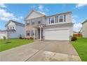 Two-story house with brick and siding, gray shutters, and a two-car garage at 340 Paulownia Cir, Mcdonough, GA 30253