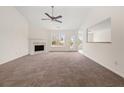 Bright living room with fireplace, plush carpet and large windows at 85 Blue Jay Dr, Covington, GA 30016