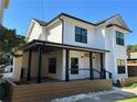 Two-story white farmhouse exterior with black accents and a porch at 429 Grant Se St, Atlanta, GA 30312