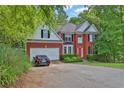 Charming brick home featuring manicured landscaping, a two-car garage, and a bright red front door at 625 Piping Rock Pt, Lawrenceville, GA 30043