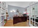 Bright office with hardwood floors, built-in shelving, and French doors, perfect for working from home at 625 Piping Rock Pt, Lawrenceville, GA 30043