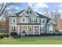 Gray two-story house with stone accents, a porch, and a neatly landscaped yard at 714 Settlers Xing, Canton, GA 30114