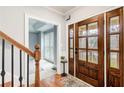 Charming foyer with hardwood floors, a staircase, and a wood front door at 2170 Charleston Pl, Lithia Springs, GA 30122