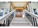 Inviting front entrance featuring a wood door and a covered porch at 2170 Charleston Pl, Lithia Springs, GA 30122