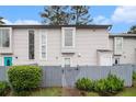 View of townhome with a tidy lawn and tall windows at 257 Country Club Dr, Jonesboro, GA 30238