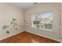 Bedroom with hardwood floors and jungle-themed wall art at 498 Anglewood Trce, Stockbridge, GA 30281