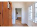 Bright entryway with hardwood floors, wood door, and view to living room with stone fireplace at 2853 N Hills Ne Dr, Atlanta, GA 30305