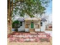 Charming cottage with a welcoming porch, green door, and fresh landscaping at 1122 Dobbs Se Dr, Atlanta, GA 30316