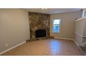 Cozy Gathering room featuring a stone fireplace and tile floors at 3959 Wood Path Dr, Stone Mountain, GA 30083