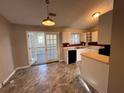 Kitchen features white cabinets, tile floors, and French doors at 3959 Wood Path Dr, Stone Mountain, GA 30083