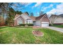 Ranch-style brick home with a two-car garage and landscaped yard at 4212 Mcgregor Way, Acworth, GA 30101