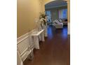 Inviting entryway featuring hardwood floors, elegant decor, and an open view into the living area at 200 Claret Way, Mcdonough, GA 30252