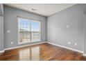 Bright, empty bedroom featuring gleaming hardwood floors and a large window with great natural light at 456 Crestmont Ln, Canton, GA 30114