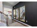 Welcoming entryway with dark accent wall, decorative mirrors, a staircase, and open view into living spaces at 128 Kingsley Way, Acworth, GA 30102