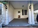 Enclosed front porch with white columns, siding and a covered ceiling at 5121 Newark Ave, Clarkdale, GA 30111